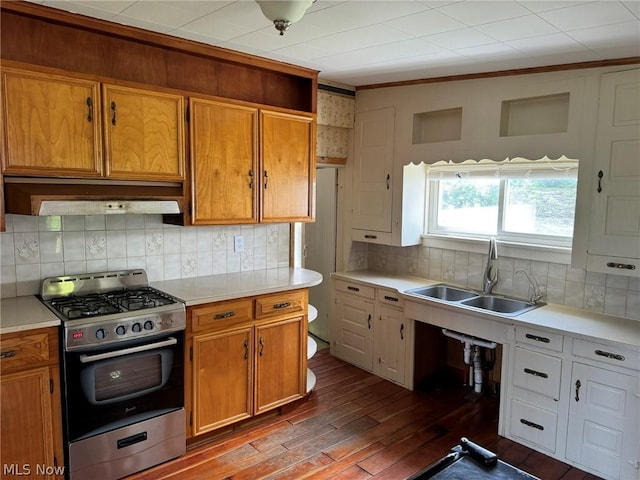 kitchen featuring hardwood / wood-style floors, sink, backsplash, and stainless steel range with gas stovetop