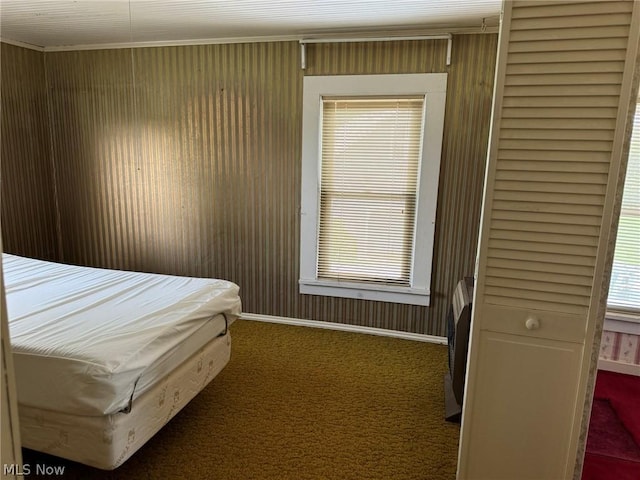 carpeted bedroom with ornamental molding