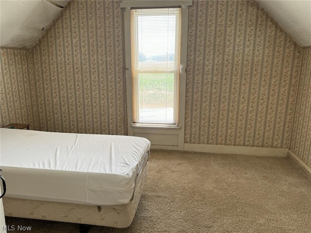 carpeted bedroom featuring vaulted ceiling