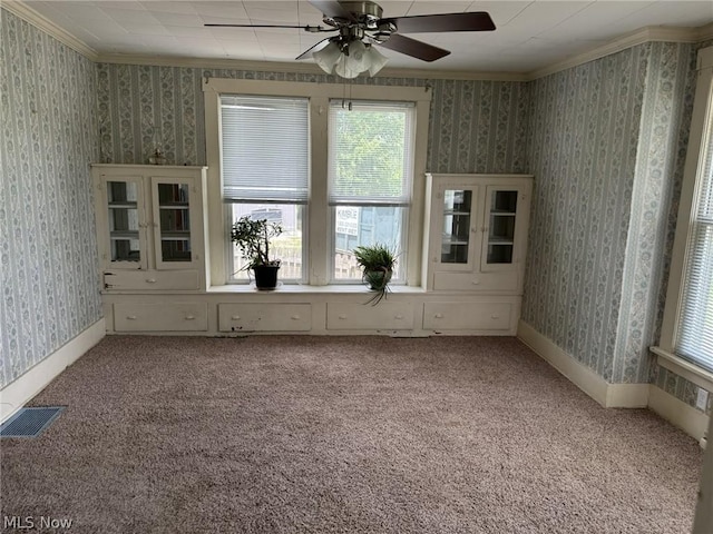 unfurnished room with carpet floors, ceiling fan, and ornamental molding