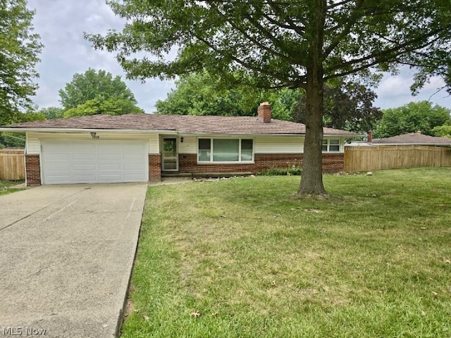 ranch-style house featuring a garage and a front lawn