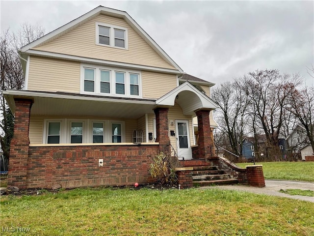 view of front of home featuring a front lawn and a porch