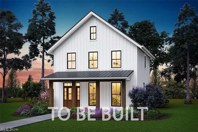 1016 Ohio Ave, Ashtabula, OH 44004 - back house at dusk featuring covered porch and a yard