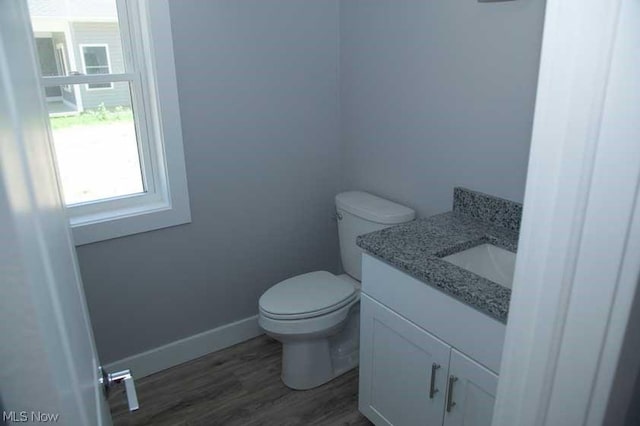 bathroom featuring hardwood / wood-style floors, vanity, and toilet