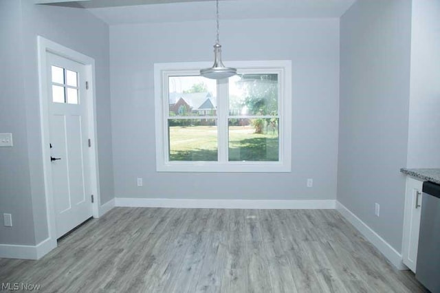 unfurnished dining area with light hardwood / wood-style flooring