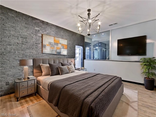 bedroom featuring light hardwood / wood-style flooring and a chandelier