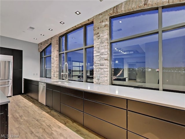 kitchen featuring light hardwood / wood-style floors, stainless steel appliances, and sink