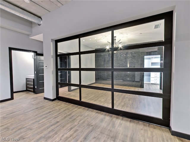 interior space featuring a chandelier and wood-type flooring