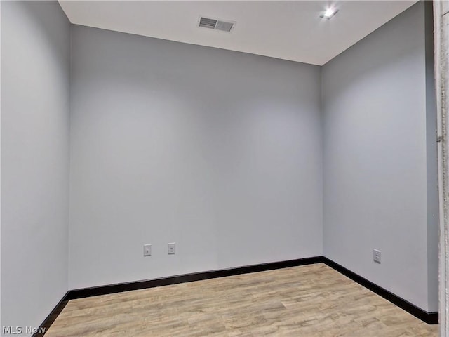 spare room with hardwood / wood-style flooring