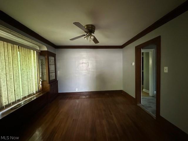 unfurnished room with dark hardwood / wood-style floors, ceiling fan, and ornamental molding