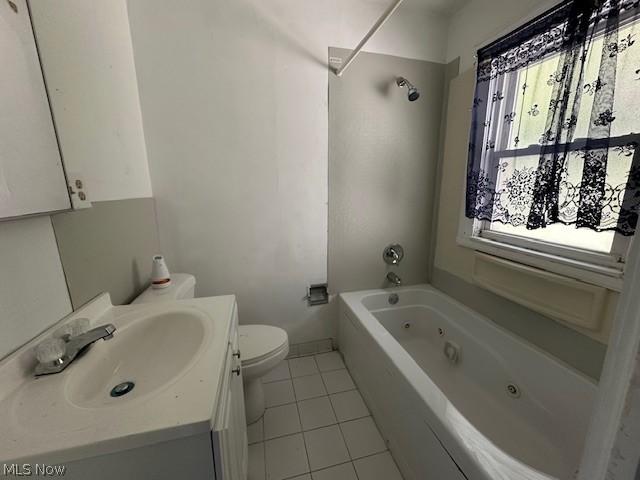 full bathroom featuring tile patterned floors, vanity, a wealth of natural light, and bathing tub / shower combination