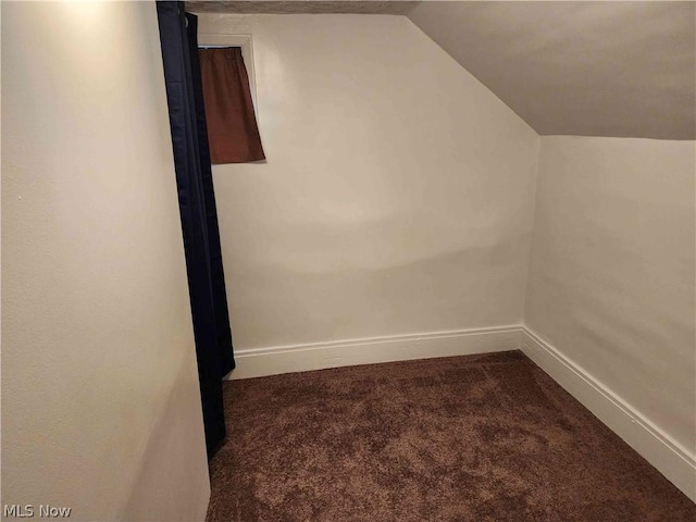 bonus room with lofted ceiling and carpet floors