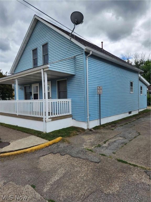 view of property exterior with a porch