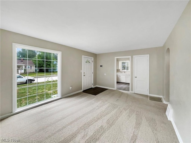 unfurnished living room with carpet flooring