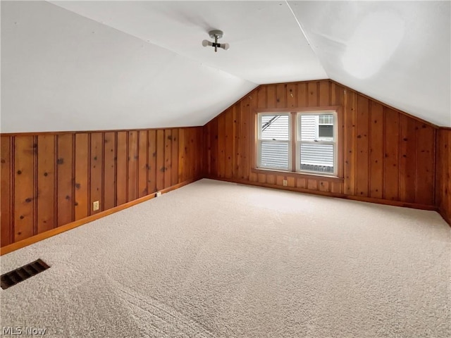 bonus room featuring lofted ceiling and carpet