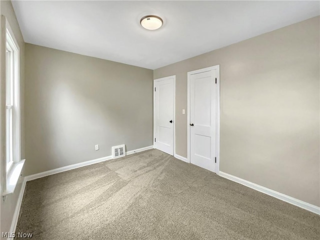 unfurnished room with carpet flooring