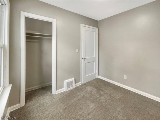 unfurnished bedroom with carpet floors and a closet