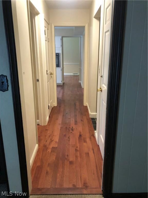 hallway featuring dark hardwood / wood-style floors