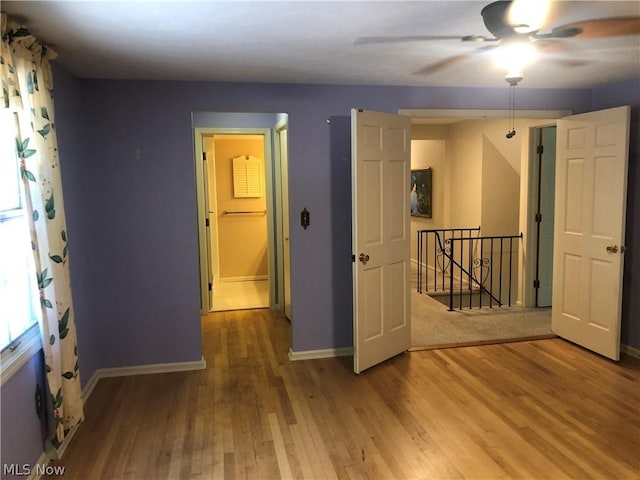 empty room featuring hardwood / wood-style floors and ceiling fan