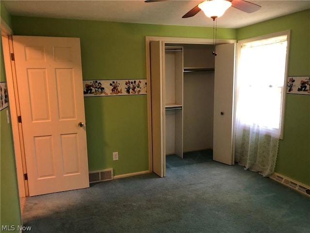 unfurnished bedroom with ceiling fan, a closet, and carpet floors