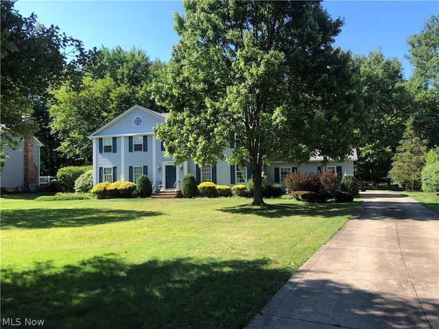 neoclassical home featuring a front yard