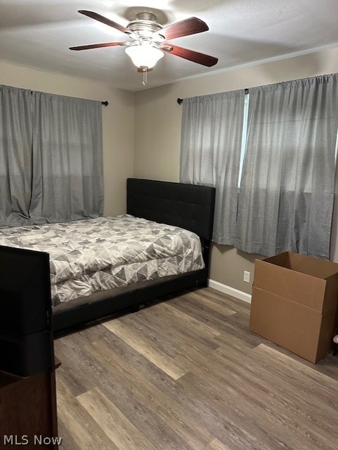 bedroom featuring wood-type flooring and ceiling fan