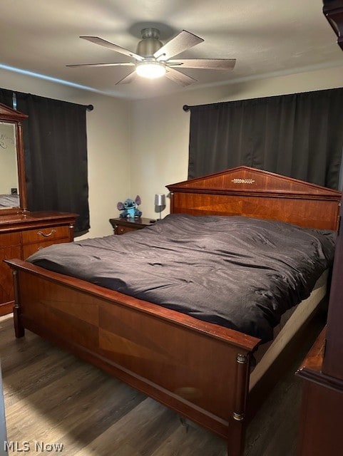 bedroom with ceiling fan and dark hardwood / wood-style flooring