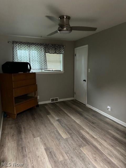 unfurnished bedroom featuring hardwood / wood-style flooring and ceiling fan