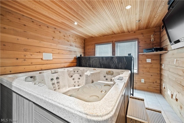 bedroom with wooden walls, light tile patterned floors, and wooden ceiling