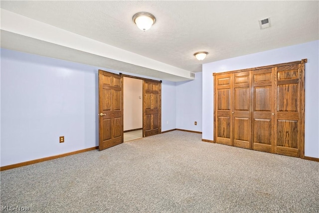 unfurnished bedroom featuring carpet floors and a closet