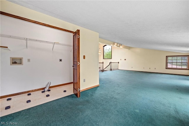 interior space with carpet flooring, a wealth of natural light, hookup for a washing machine, and hookup for an electric dryer