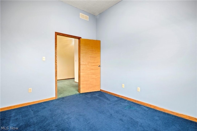 empty room featuring carpet floors and a textured ceiling