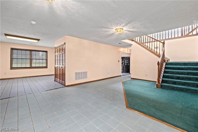 unfurnished living room with a textured ceiling