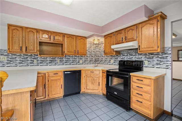 kitchen with decorative backsplash, light tile patterned floors, sink, and black appliances