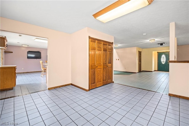 spare room featuring light tile patterned floors