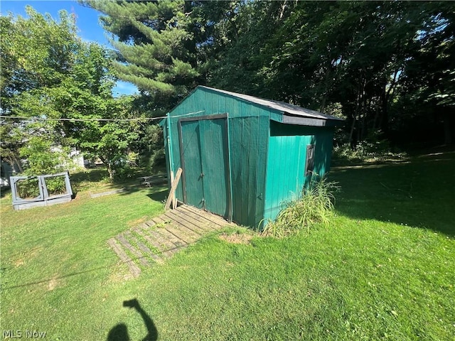 view of outbuilding with a yard