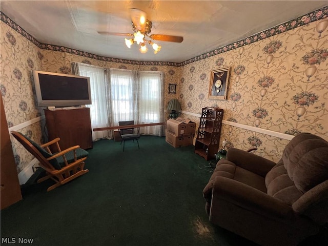 living area with carpet floors and ceiling fan