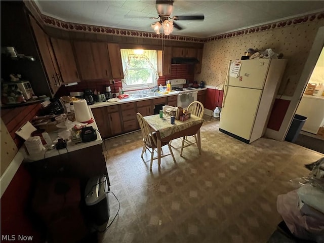 kitchen featuring ceiling fan, sink, and white appliances