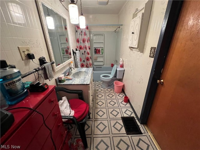 full bathroom featuring vanity, shower / tub combination, and toilet