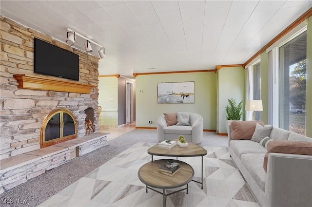 carpeted living room with a stone fireplace and crown molding