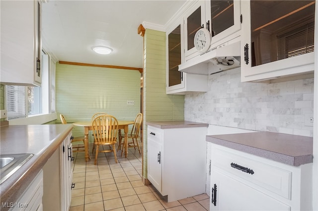 kitchen featuring ornamental molding, white cabinetry, backsplash, and light tile patterned flooring