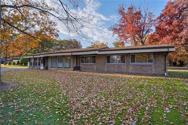 ranch-style home featuring a front yard and a sunroom