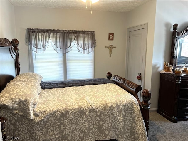 bedroom with a textured ceiling and carpet flooring