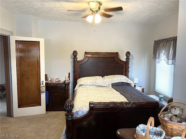 bedroom with carpet floors, a textured ceiling, and a ceiling fan