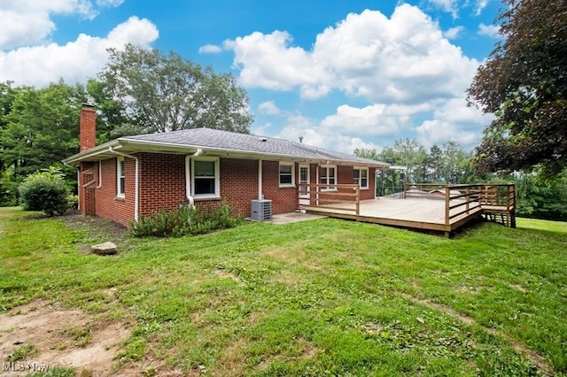 back of house with a yard and a deck