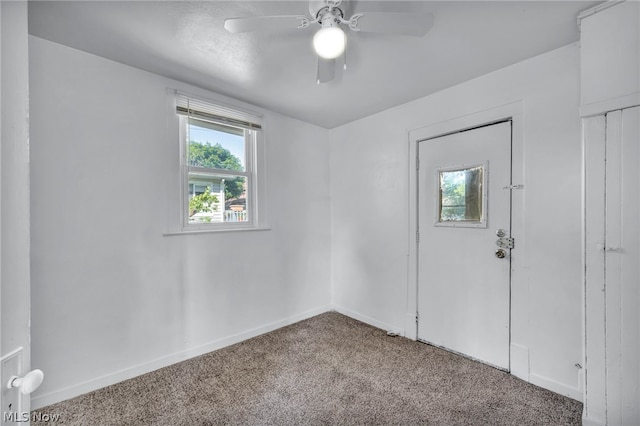 unfurnished room with ceiling fan and light colored carpet