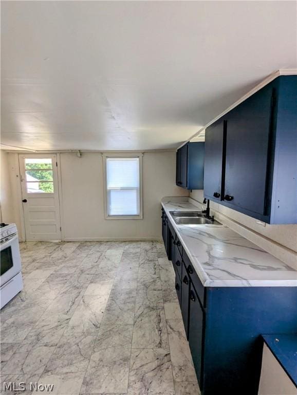 kitchen featuring white stove, blue cabinets, and sink