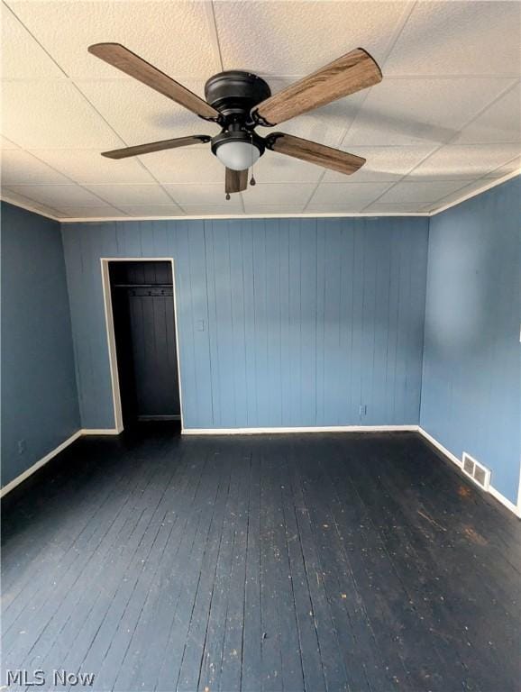 unfurnished room featuring ceiling fan and dark wood-type flooring