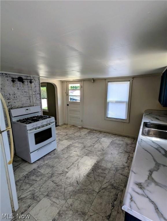 kitchen featuring white appliances and sink