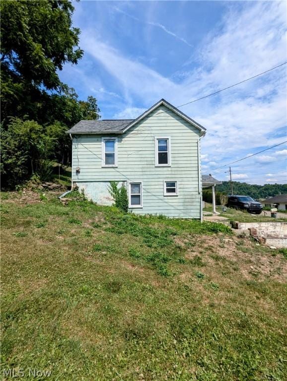 view of side of home featuring a yard